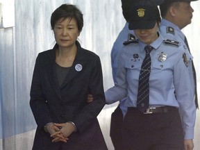 FILE - In this Oct. 10, 2017, file photo, former South Korean President Park Geun-hye, left, arrives to attend a hearing on the extension of her detention at the Seoul Central District Court in Seoul, South Korea. Prosecutors on Tuesday, Feb. 27, 2018 have demanded a 30-year prison term for Park for alleged bribery, abuse of power and other crimes in a landmark corruption case that marked a stunning fall from grace for the country's first female leader and former conservative icon.