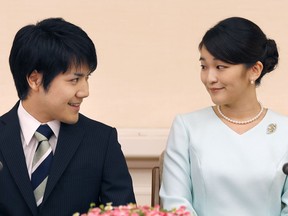 FILE - In this Sept. 3, 2017, file photo, Japan's Princess Mako, the elder daughter of Prince Akishino and Princess Kiko, and her fiance Kei Komuro, look at each other during a press conference at Akasaka East Residence in Tokyo. According to Japanese media, the Imperial Household Agency said Tuesday, Feb. 6, 2018 that Princess Mako's wedding, planned for November, will be delayed until 2020, citing lack of time for preparations.