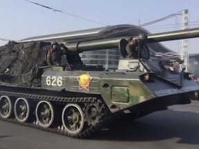 This image taken from video footage provided by Paektu Cultural Exchange shows military vehicles through streets in Pyongyang, North Korea, Thursday, Feb. 8, 2018. North Korea held a military parade and rally on Kim Il Sung Square on Thursday, just one day before South Korea holds the opening ceremony for the Pyeongchang Winter Olympics. (AP Photo)
