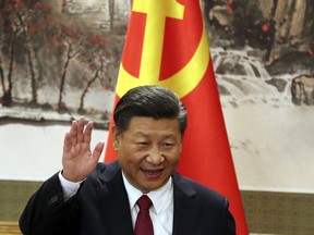 FILE - In this Oct. 25, 2017, file photo, Chinese President Xi Jinping waves while addressing the media as he introduced new members of the Politburo Standing Committee at Beijing's Great Hall of the People. China's official news agency said Sunday, Feb. 25, 2018, the ruling Communist Party proposed removing a limit of two consecutive terms for the country's president and vice president. The move, if approved, appears to lay the groundwork for party leader Xi to rule as president beyond 2023.