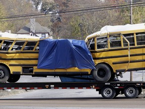 FILE-A school bus is carried away in this Tuesday, Nov. 22, 2016, file photo, in Chattanooga, Tenn, from the site where it crashed Monday, Nov. 21. The bus driver, Johnthony Walker  was on his cellphone and driving 20 mph