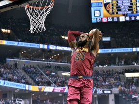 Cleveland Cavaliers forward LeBron James goes up for a dunk during the first half of an NBA basketball game against the Memphis Grizzlies on Friday, Feb. 23, 2018, in Memphis, Tenn.