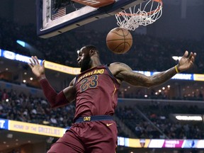 Cleveland Cavaliers forward LeBron James dunks during the first half of the team's NBA basketball game against the Memphis Grizzlies on Friday, Feb. 23, 2018, in Memphis, Tenn.