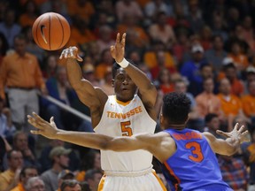 Tennessee forward Admiral Schofield (5) passes the ball away from Florida guard Jalen Hudson (3) in the first half of an NCAA college basketball game Wednesday, Feb. 21, 2018, in Knoxville, Tenn.
