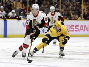 Ottawa Senators right wing Mark Stone (61) moves the puck away from Nashville Predators left wing Kevin Fiala (22), of Switzerland, in the first period of an NHL hockey game Monday, Feb. 19, 2018, in Nashville, Tenn.