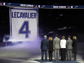 Former Tampa Bay Lightning center Vincent Lecavalier, third from left, is joined by family members during his jersey retirement ceremony before an NHL hockey game against the Los Angeles Kings, Saturday, Feb. 10, 2018, in Tampa, Fla.