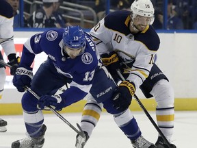 Tampa Bay Lightning center Cedric Paquette (13) and Buffalo Sabres center Jacob Josefson (10) vie for control of the puck during the first period of an NHL hockey game Wednesday, Feb. 28, 2018, in Tampa, Fla.