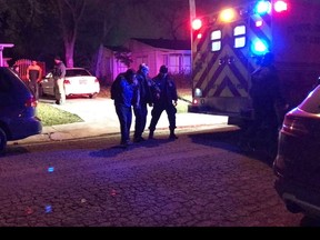 Medics and officers escort a man as he walks to an ambulance in Corpus Christi, Texas. A man believed to be in his 30s is in police custody after four people were stabbed Wednesday, Feb. , 7, 2018 evening during a church service inside a residence in Corpus Christi.