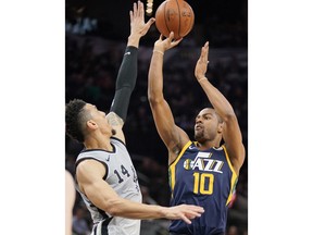 Utah Jazz' Alec Burks (10) shoots against San Antonio Spurs' Danny Green during the first half of an NBA basketball game, Saturday, Feb. 3, 2018, in San Antonio.