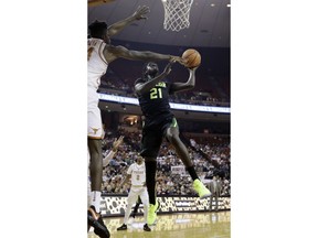 Baylor forward Nuni Omot (21) drives to the basket against Texas forward Mohamed Bamba (4) during the first half of an NCAA college basketball game, Monday, Feb. 12, 2018, in Austin, Texas.