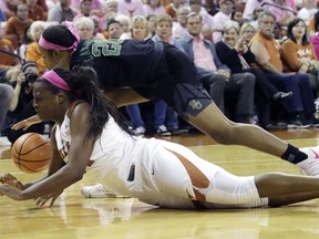 Texas guard Joyner Holmes, front, and Baylor guard Juicy Landrum, back, chase a loose ball during the first half of an NCAA college basketball game, Monday, Feb. 19, 2018, in Austin, Texas.