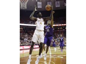 Texas forward Mohamed Bamba (4) grabs a rebound over Kansas State forward James Love III (21) during the first half of an NCAA college basketball game Wednesday, Feb. 7, 2018, in Austin, Texas.