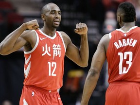 Houston Rockets forward Luc Mbah a Moute (12) celebrates after drawing a foul, as guard James Harden watches during the first half of the team's NBA basketball game against the Sacramento Kings, Wednesday, Feb. 14, 2018, in Houston.