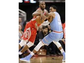 Houston Rockets guard Chris Paul, left, is fouled by Sacramento Kings guard Garrett Temple during the first half of an NBA basketball game Wednesday, Feb. 14, 2018, in Houston.