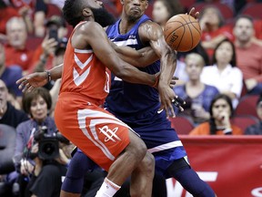 Houston Rockets guard James Harden (13) is fouled on his shot attempt by Minnesota Timberwolves guard Jimmy Butler (23) during the first half of an NBA basketball game Friday, Feb. 23, 2018, in Houston.