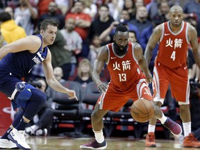 Houston Rockets guard James Harden (13) chases down the ball in front of Minnesota Timberwolves forward Nemanja Bjelica, left, as Rockets forward PJ Tucker (4) watches during the second half of an NBA basketball game Friday, Feb. 23, 2018, in Houston.