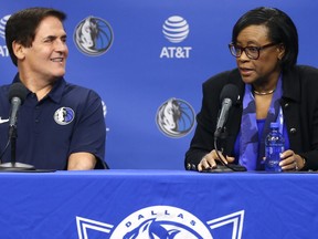 Dallas Mavericks owner Mark Cuban, left, looks on as Cynthia Marshall, new interim CEO of the team, addresses the media Monday, Feb. 26, 2018, in Dallas.