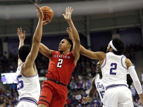 Texas Tech guard Zhaire Smith (2) goes up for a shot over TCU guard's Alex Robinson (25) and Shawn Olden (2) during the first half of an NCAA college basketball game, Saturday, Feb. 3, 2018 in Fort Worth, Texas.