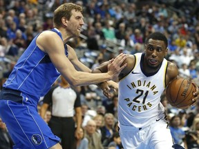 Dallas Mavericks forward Dirk Nowitzki, left, defends as Indiana Pacers forward Thaddeus Young (21) drives inside during the first half of an NBA basketball game, Monday, Feb. 26, 2018, in Dallas.