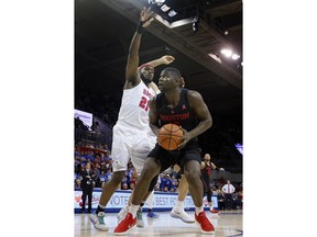 SMU guard Ben Emelogu II (21) defends as Houston forward Nura Zanna (13) of Nigeria positions for a shot in the first half of an NCAA college basketball game Wednesday, Feb. 28, 2018, in Dallas.