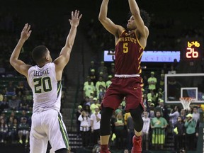 Iowa State guard Lindell Wigginton, right, scores over Baylor guard Manu Lecomte, left, during the first half of an NCAA college basketball game, Saturday, Feb. 3, 2018, in Waco, Texas.