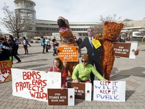 People gather to stand in support of Bears Ears and Grand Staircase-Escalante National Monuments on the day Interior Secretary Ryan Zinke is speaking during a conservation and hunting expo Friday, Feb. 9, 2018, in Salt Lake City. Protests are planned by environmental groups who are upset that Zinke recommended shrinking two sprawling national monuments in Utah.