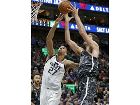 Utah Jazz center Rudy Gobert (27) and San Antonio Spurs center Pau Gasol, right, reach for a rebound in the first half during an NBA basketball game Monday, Feb. 12, 2018, in Salt Lake City.