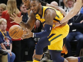 Utah Jazz forward Jae Crowder, right, and Phoenix Suns forward TJ Warren, rear, battle for a loose ball in the first half during an NBA basketball game Wednesday, Feb. 14, 2018, in Salt Lake City.
