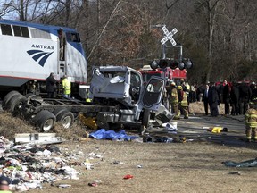 Emergency personnel work at the scene of a train crash involving a garbage truck in Crozet, Va., on Wednesday, Jan. 31, 2018. An Amtrak passenger train carrying dozens of GOP lawmakers to a Republican retreat in West Virginia struck a garbage truck south of Charlottesville, Va. No lawmakers were believed injured.