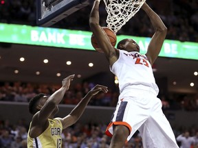 Virginia's Nigel Johnson (23) dunks over Georgia Tech's Moses Wright (12) during the second half of an NCAA college basketball game Wednesday, Feb. 21, 2018, in Charlottesville, Va.