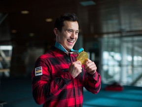Figure skater Patrick Chan, of Toronto, holds his 2018 Olympic gold medal after arriving from South Korea at Vancouver International Airport in Richmond, B.C., on Monday February 26, 2018.