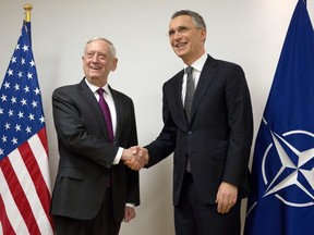 NATO Secretary General Jens Stoltenberg, right, shakes hands with U.S. Secretary for Defense Jim Mattis prior to a meeting at NATO headquarters in Brussels on Wednesday, Feb. 14, 2018. NATO defense ministers begin a two-day meeting Wednesday to focus on military spending, cooperation with the European Union, and assistance to the Iraqi army.