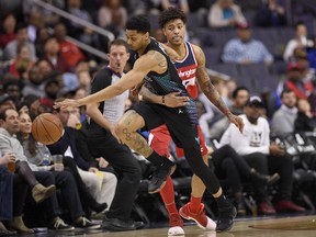 Washington Wizards forward Kelly Oubre Jr., right, fouls Charlotte Hornets guard Jeremy Lamb, left, during the first half of an NBA basketball game, Friday, Feb. 23, 2018, in Washington.