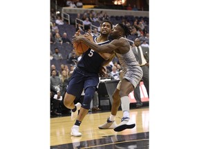 Georgetown guard Jonathan Mulmore, right, fight for the ball against Xavier guard Trevon Bluiett (5) during the first half of an NCAA college basketball game, Wednesday, Feb. 21, 2018, in Washington.