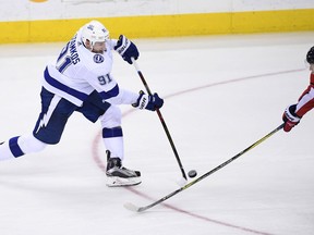 Tampa Bay Lightning center Steven Stamkos (91) shoots the puck as Washington Capitals' Christian Djoos, of Sweden, defends during the third period of an NHL hockey game Tuesday, Feb. 20, 2018, in Washington. The Lightning won 4-2.