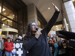 FILE - In this Jan. 16, 2018, file photo, Maru Mora-Villalpando acknowledges supporters surrounding her at a news conference announcing that the longtime activist for illegal immigrants in the Northwest says she herself is now facing deportation, in Seattle. Human rights experts with the United Nations are calling on the U.S. to protect immigrant rights activists from deportation, saying they're concerned about "an increasing pattern of intimidation and retaliation against people defending migrants' rights." In a statement Wednesday, Feb. 14, 2018, a Geneva-based group with the U.N.'s Office of the High Commissioner for Human Rights said deportation proceedings against Seattle-area activist Mora-Villalpando appeared to be in retaliation for her political work.