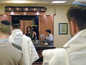 The head of Warsaw's Jewish community, Anna Chipczynska, center left, celebrates the Sabbath along with others in a synagogue in Warsaw, Poland, Saturday, Feb. 10, 2018. Many members of Poland's small Jewish community have been left feeling stunned and scared by an eruption of anti-Semitic rhetoric in mainstream Polish public debate. The hostile rhetoric, unheard in public life in decades, comes amid a diplomatic crisis with Israel over a new Polish law that criminalizes some forms of Holocaust speech.