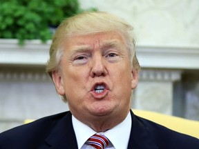 President Donald Trump speaks about domestic violence during a working session regarding the opportunity zones provided by tax reform in the Oval Office of the White House, Wednesday, Feb. 14, 2018, in Washington. Trump responded to a question and said, "I am totally opposed to domestic violence of any kind everyone knows that and it almost wouldn't even have to be said."