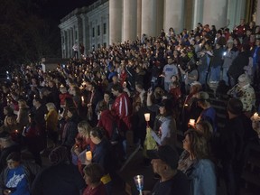 Hundreds attend a candlelight rally in support of the ongoing statewide teachers walkout outside of the capitol building in Charleston, W.V., on Sunday, Feb. 25, 2018.