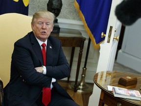 In this Feb. 2, 2018, photo, President Donald Trump speaks during a meeting with North Korean defectors where he talked with reporters about allowing the release of a secret memo on the FBI's role in the Russia inquiry, in the Oval Office of the White House in Washington. Ignoring the objections of the Justice Department and warnings from his own staff, Trump's authorization of the release of a bitterly disputed, formerly highly classified memo was his latest contentious move to upend the investigation into his campaign's ties to Russia or whether the president obstructed justice.