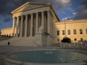 In this Oct. 10, 2017 photo, the Supreme Court in Washington is seen at sunset. The Supreme Court says whistleblower protections passed by Congress after the 2008 financial crisis only apply to people who report problems to the government, not more broadly. The justices ruled Wednesday that a part of the Dodd-Frank Act that protects whistleblowers from being fired, demoted or harassed only applies to people who report legal violations to the U.S. Securities and Exchange Commission.