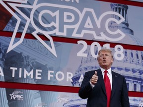 In this Feb. 23, 2018, photo, President Donald Trump gives a thumbs up after speaking at the Conservative Political Action Conference In Oxon Hill, Md. On the offensive about his record and the defensive about the Russia investigation, Trump sought in a week's worth of rhetoric to show that he is outdoing his predecessor, if not all of history. This made for inflated claims.