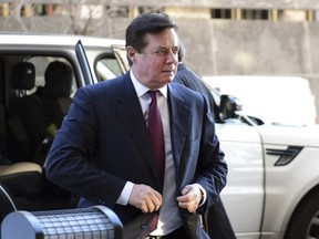 FILE - In this Dec. 11, 2017, file photo, former Trump campaign chairman Paul Manafort arrives at federal court in Washington. In a dramatic escalation of pressure and stakes, special counsel Robert Mueller filed additional criminal charges Feb. 22, 2018, against Manafort and his business associate, Rick Gates.