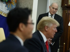 FILE - In this Feb. 2, 2018, file photo, White House Chief of Staff John Kelly listens during a meeting between President Donald Trump and North Korean defectors in the Oval Office of the White House in Washington. The White House says Trump remains confident in Kelly even though Kelly defended an aide who'd been accused of domestic abuse by his two ex-wives. Spokesman Raj Shah says Trump was not aware of the allegations against former staff secretary Rob Porter until Tuesday.
