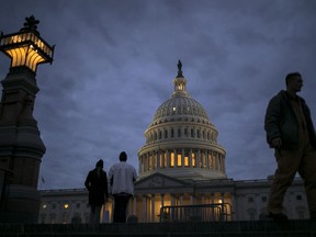 In this Jan. 21, 2018, file photo, lights illuminate the U.S. Capitol on second day of the federal shutdown as lawmakers negotiate behind closed doors in Washington. The era of trillion-dollar budget deficits is about make a comeback _ and a brewing budget deal hastened the arrival. Lawmakers are inching closer to a two-year, budget-busting spending pact that would give whopping budget increases to both the Pentagon and domestic programs have been inching closer to an agreement, according to aides and members of Congress.