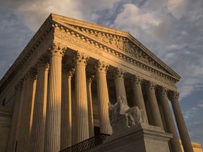 FILE - In this Oct. 10, 2017, file photo, the Supreme Court in Washington, at sunset. The Supreme Court is hearing arguments in a case that could deal a painful financial blow to organized labor. All eyes will be on Justice Neil Gorsuch on Monday, Feb. 26, 2018, when the court takes up a challenge to an Illinois law that allows unions representing government employees to collect fees from workers who choose not to join. The unions say the outcome could affect more than 5 million government workers in 24 states and the District of Columbia.