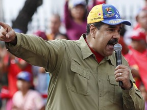 Venezuela's President Nicolas Maduro addresses supporters during a rally marking the anniversary of the 1992 failed coup led by late President Hugo Chavez in Caracas, Venezuela, Sunday, Feb. 4, 2018. Maduro will run for reelection in this year's presidential election.