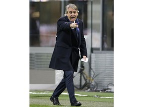 FILE - In this March 12, 2016 file photo, Inter Milan coach Roberto Mancini shouts instructions during the Serie A soccer match between Inter Milan and Bologna at the San Siro stadium in Milan, Italy. The Italian soccer federation has talked to Roberto Mancini about the possibility of becoming the next coach of the national team. The 53-year-old Mancini, who has coached Manchester City and Inter Milan, is among several candidates for the role -- along with current Chelsea coach Antonio Conte, Carlo Ancelotti and Claudio Ranieri.