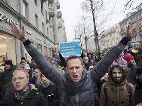 FILE -  In this file photo taken on Sunday, Jan. 28, 2018, Russian opposition leader Alexei Navalny, centre, attends a rally in Moscow, Russia. Russia's communication providers have blocked access to the website of opposition leader Alexei Navalny on orders of the state communications watchdog. The agency, Roskomnadzor, demanded that Navalny remove a video alleging that Deputy Prime Minister Sergei Prikhodko received lavish hospitality from billionaire Oleg Deripaska following a court order or face his web resources being shut.