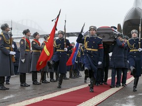 Russian officers carry a coffin with the body of Russian Roman Filipov, the pilot of the Su-25 jet who ejected after Syrian insurgents shot down his plane traded fire with militants on the ground and then blew himself up to avoid being captured, during a funeral service in Voronezh, Russia, Thursday, Feb. 8, 2018.